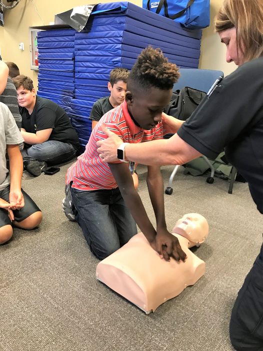 Dep. Darlene Ricks demonstrates how to perform cardiopulmonary resuscitation to Junior Deputy Academy program participants.