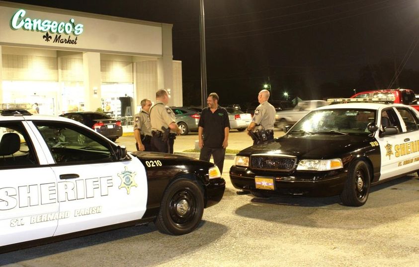 St. Bernard Sheriff’s Office Reserve Division deputies chat with the manager of