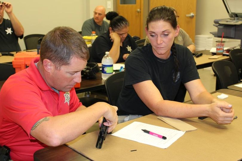 Sgt. David Culpepper, left, gives Dep. Dixie Dusang instruction on how to proper